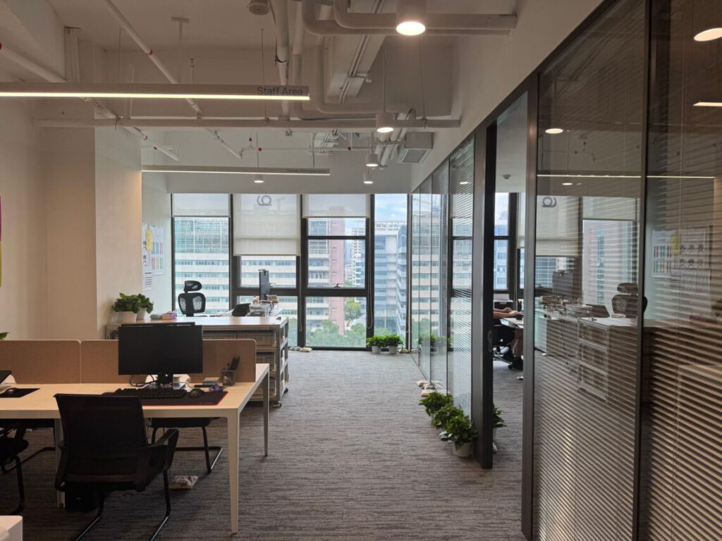 Bright, modern office interior with large windows and open workspace design.